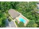 Aerial view of community clubhouse and pool area surrounded by mature trees at 7645 Briarstone Ln, Indianapolis, IN 46227