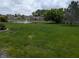 Expansive backyard with lush green lawn and a serene pond featuring a fountain at 7645 Briarstone Ln, Indianapolis, IN 46227
