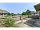 Backyard view featuring a patio, partial fence, and a serene community pond at 7645 Briarstone Ln, Indianapolis, IN 46227