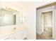 Bathroom vanity and mirror next to doorway at 7645 Briarstone Ln, Indianapolis, IN 46227