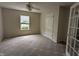 Bright bedroom featuring neutral colors, a ceiling fan, and a window providing natural light, creating a relaxing space at 7645 Briarstone Ln, Indianapolis, IN 46227