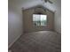 Bedroom featuring a vaulted ceiling and a large window with natural light streaming in at 7645 Briarstone Ln, Indianapolis, IN 46227