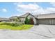 This home features an attached three-car garage, neat landscaping, and beautiful shrubbery on the front lawn at 7645 Briarstone Ln, Indianapolis, IN 46227