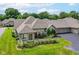 Well-maintained home featuring a beautiful landscaped front yard, charming shrubbery, and an attached three-car garage at 7645 Briarstone Ln, Indianapolis, IN 46227