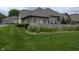 Well-maintained exterior with a lush green lawn and privacy fence offering curb appeal and tranquility at 7645 Briarstone Ln, Indianapolis, IN 46227