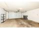 Garage featuring a garage door, storage rack, and trash bins at 7645 Briarstone Ln, Indianapolis, IN 46227