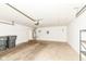Garage featuring a garage door, storage rack, and trash bins at 7645 Briarstone Ln, Indianapolis, IN 46227