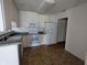 Kitchen area featuring white appliances, modern fixtures, and doorway at 7645 Briarstone Ln, Indianapolis, IN 46227