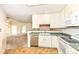 Bright kitchen featuring stainless steel dishwasher and green countertops at 7645 Briarstone Ln, Indianapolis, IN 46227
