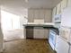 A view of the kitchen featuring white cabinets, modern appliances, and a laminate countertop at 7645 Briarstone Ln, Indianapolis, IN 46227