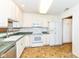 Functional kitchen featuring white cabinetry, laminate countertops, and essential appliances at 7645 Briarstone Ln, Indianapolis, IN 46227