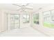 Sunlit living room with a sliding glass door and three large windows at 7645 Briarstone Ln, Indianapolis, IN 46227