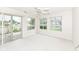 Sunlit living room with a sliding glass door and three large windows at 7645 Briarstone Ln, Indianapolis, IN 46227