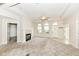 Bright living room featuring a fireplace, neutral carpet, and large windows allowing for plenty of natural light at 7645 Briarstone Ln, Indianapolis, IN 46227