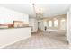 Open-concept living room featuring natural light, a fireplace, and an opening to the kitchen and dining area at 7645 Briarstone Ln, Indianapolis, IN 46227