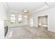 Bright living room featuring a fireplace, neutral carpet, and large windows allowing for plenty of natural light at 7645 Briarstone Ln, Indianapolis, IN 46227