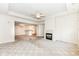 Spacious carpeted living room with a fireplace and views of the dining area and kitchen at 7645 Briarstone Ln, Indianapolis, IN 46227