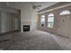 Bright living room boasts a fireplace, large windows, and neutral carpet, creating a cozy atmosphere at 7645 Briarstone Ln, Indianapolis, IN 46227