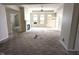 Open living room with fireplace, multiple windows, and doorway to another room at 7645 Briarstone Ln, Indianapolis, IN 46227