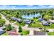 An aerial shot showcasing a community centered around a serene lake, surrounded by beautiful homes and greenery at 7670 Lippincott Way, Indianapolis, IN 46268