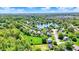 Scenic aerial view of a residential area with a charming lake, tree-lined streets, and well-kept homes at 7670 Lippincott Way, Indianapolis, IN 46268