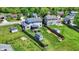 Sprawling backyard aerial of home featuring lawn, sheds, and a screened in porch at 7670 Lippincott Way, Indianapolis, IN 46268