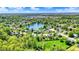 Picturesque aerial view showcases a serene lake community with lush greenery and well-maintained homes at 7670 Lippincott Way, Indianapolis, IN 46268