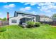 Expansive backyard features lush green lawn and a charming screened-in porch at 7670 Lippincott Way, Indianapolis, IN 46268