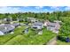 Aerial view of a property with a spacious, fenced backyard, green lawn, outbuildings, and neighboring houses at 7670 Lippincott Way, Indianapolis, IN 46268
