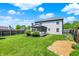 Spacious backyard features lush green lawn, landscape beds, and a screened-in porch at 7670 Lippincott Way, Indianapolis, IN 46268