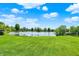 Tranquil backyard featuring a spacious lawn and serene lake views at 7670 Lippincott Way, Indianapolis, IN 46268