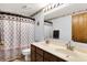 Bright bathroom featuring a double vanity and patterned shower curtain offers functionality and style at 7670 Lippincott Way, Indianapolis, IN 46268