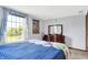 Bright bedroom with a large window, comfortable bed, and classic wood dresser creates a relaxing personal retreat at 7670 Lippincott Way, Indianapolis, IN 46268
