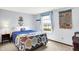 Cozy bedroom with a bright window, soft carpet, and a colorful quilt on the bed creates a warm and inviting atmosphere at 7670 Lippincott Way, Indianapolis, IN 46268