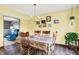 Cozy dining room featuring hardwood floors, bright yellow walls, and elegant chandelier at 7670 Lippincott Way, Indianapolis, IN 46268