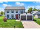 Charming two-story home with an attached two-car garage, a red front door and well-manicured lawn at 7670 Lippincott Way, Indianapolis, IN 46268