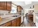 Well-maintained kitchen with tile backsplash, hardwood floors and stainless steel appliances at 7670 Lippincott Way, Indianapolis, IN 46268