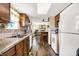 Traditional eat-in kitchen featuring wood cabinets, granite counters and wood floors at 7670 Lippincott Way, Indianapolis, IN 46268