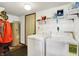 Functional laundry room with washer, dryer, water heater and shelving at 7670 Lippincott Way, Indianapolis, IN 46268