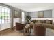Bright living room with large windows, stylish decor, and comfortable seating arrangement at 7670 Lippincott Way, Indianapolis, IN 46268