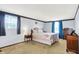 Spacious main bedroom with large windows, plush carpet, and ample natural light at 7670 Lippincott Way, Indianapolis, IN 46268