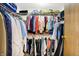 Well-organized walk-in closet with double hanging rods and shelving provides ample storage space for clothing and accessories at 7670 Lippincott Way, Indianapolis, IN 46268