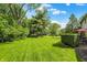Spacious backyard featuring a well-manicured lawn, mature trees, and a patio area for outdoor entertaining at 781 Dayton Dr, Carmel, IN 46033