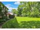 Expansive backyard featuring a well-maintained lawn, mature trees, and a private, serene setting at 781 Dayton Dr, Carmel, IN 46033