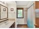 Bathroom with wooden cabinets, tile flooring and shower, and a window bringing in natural light at 781 Dayton Dr, Carmel, IN 46033