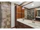 Elegant bathroom showcasing a double vanity with dark wood cabinets and a tiled shower with glass door at 781 Dayton Dr, Carmel, IN 46033