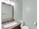 Bathroom featuring a modern vanity with granite countertop, silver framed mirror, and ceramic toilet at 781 Dayton Dr, Carmel, IN 46033