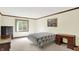 Comfortable bedroom featuring neutral decor, a plush bed, a large window, and classic furnishings at 781 Dayton Dr, Carmel, IN 46033