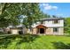 Two-story home with stone facade, attached garage, mature trees, and manicured lawn at 781 Dayton Dr, Carmel, IN 46033