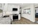 Updated kitchen with white cabinets, stainless appliances, granite counters, and wood-look floors at 781 Dayton Dr, Carmel, IN 46033
